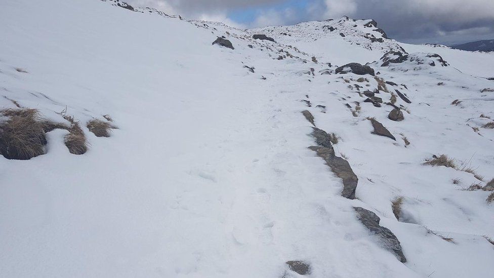 Snow on the highest mountain of Wales recently made conditions difficult for hikers