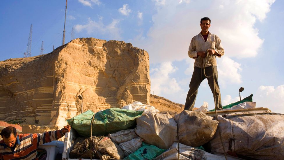 A Zabaleen ties up sacks of garbage on his truck near the Cairo suburb of Moqqatam