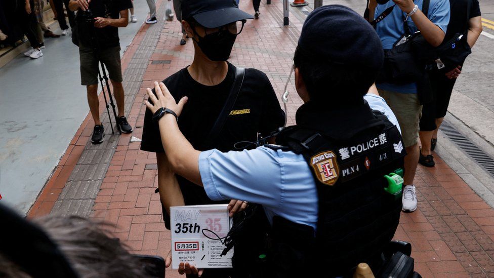 Police detain a man with the scripts of titled "May 35", a reference to the 4 June 1989 Tiananmen Square massacre in Beijing