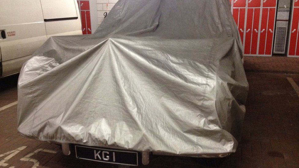 The Rolls Royce Phantom covered up in the car park