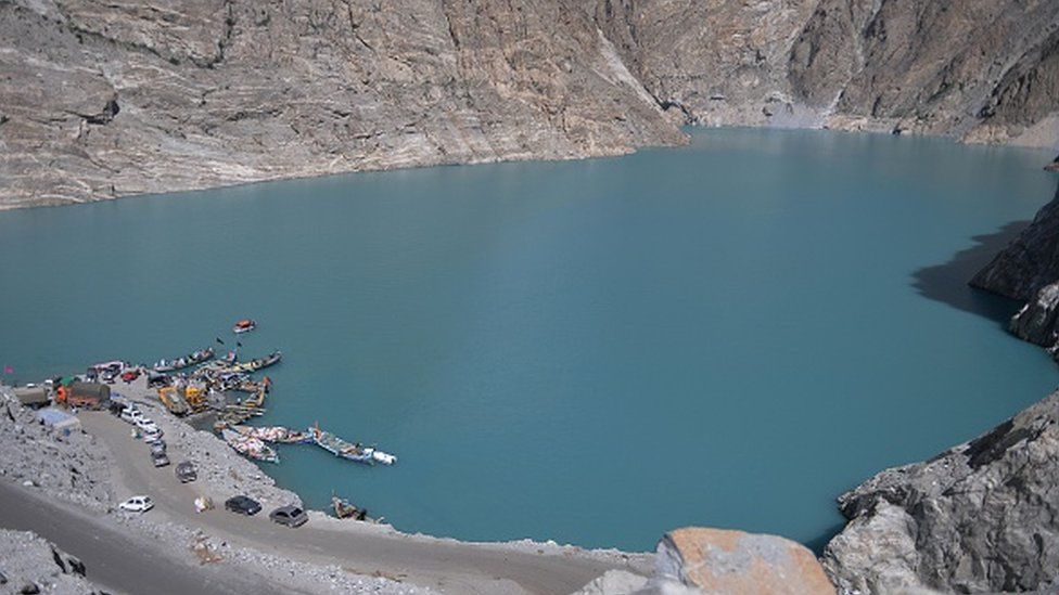 Pakistani residents board boats used to cross Attabad Lake