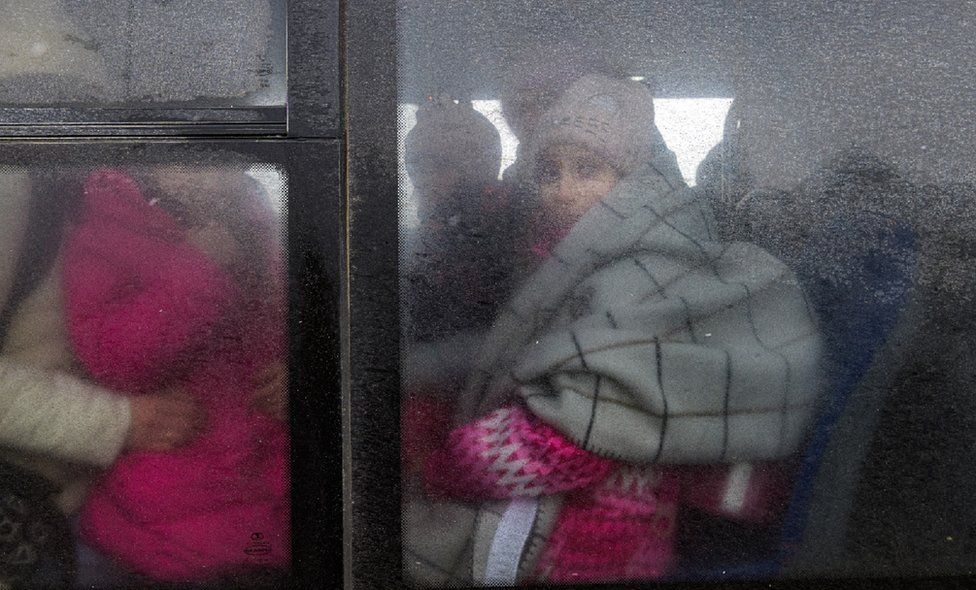 Refugees through a rainy window