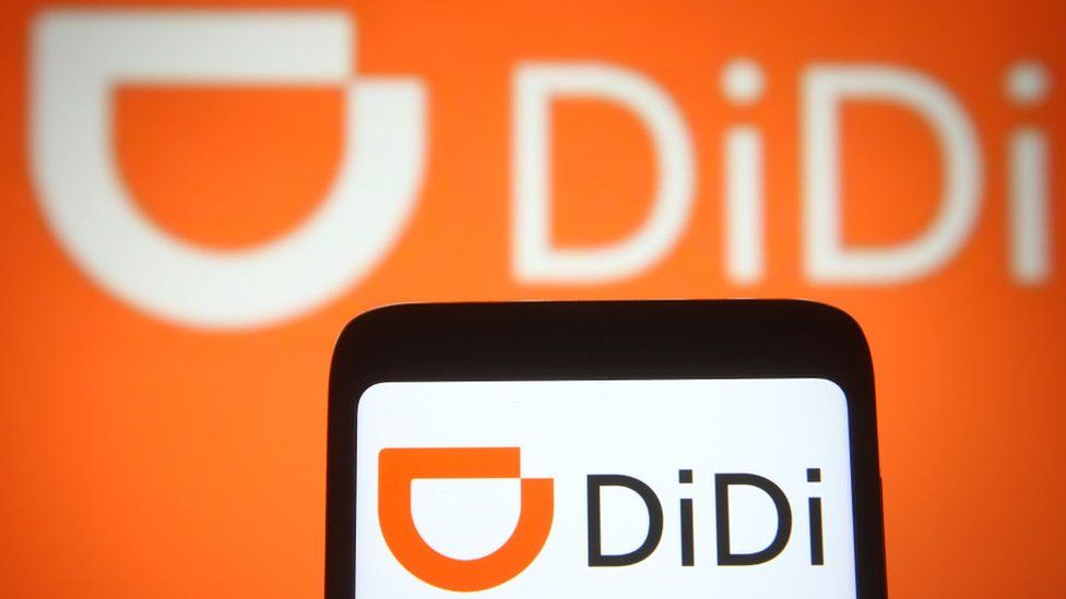 DiDi logo on a smartphone and a PC screen.
