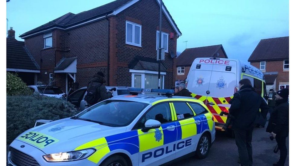 Police search a house in Crawley