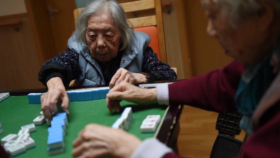 Elderly people playing dominoes in a Chinese nursing home