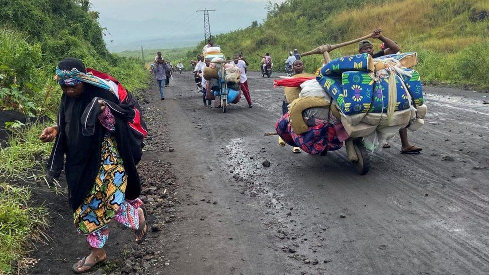 Civilians flee an advance by M23 rebels in DR Congo