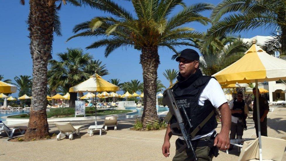 Policeman by swimming pool in Sousse - 26 June