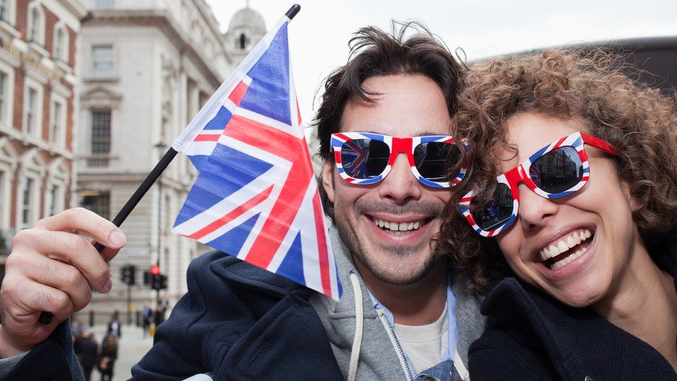 couple with union jack glasses and flag
