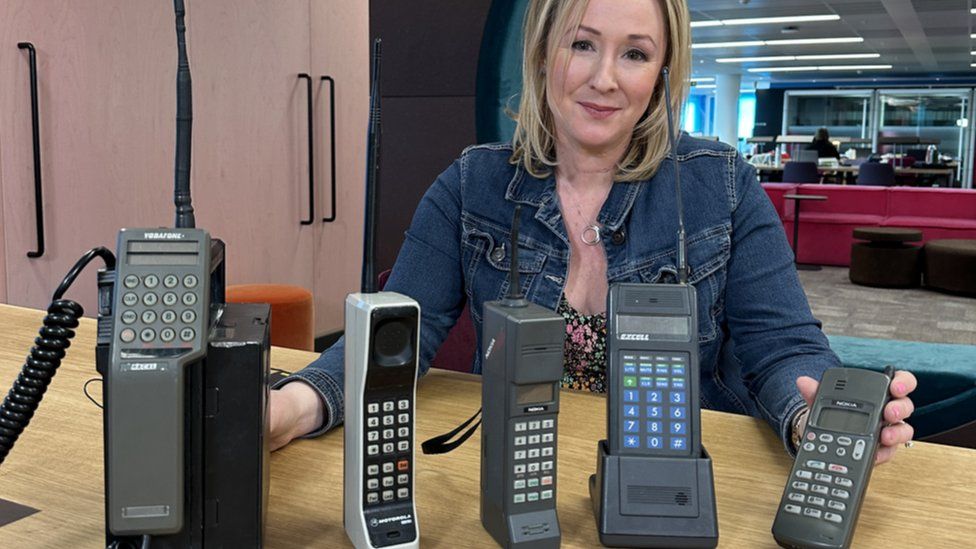 Zoe Kleinman with some phones from the 1980s and 90s