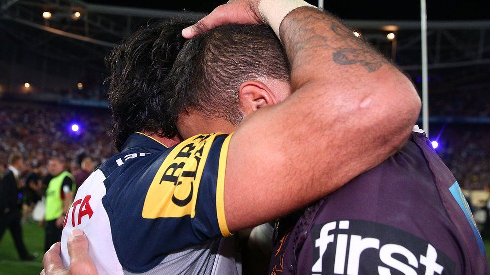 Johnathan Thurston of the Cowboys consoles with Justin Hodges of the Broncos after the 2015 NRL Grand Final match between the Brisbane Broncos and the North Queensland Cowboys at ANZ Stadium on 4 October 2015 in Sydney,