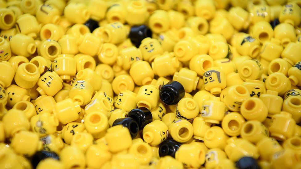 A container of Lego heads