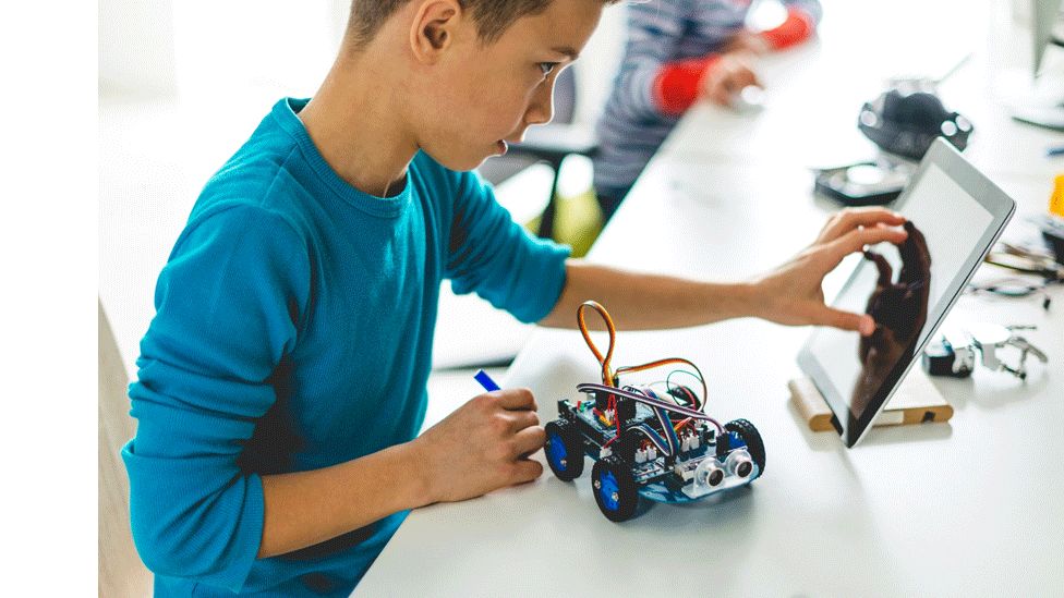 A boy building a robot