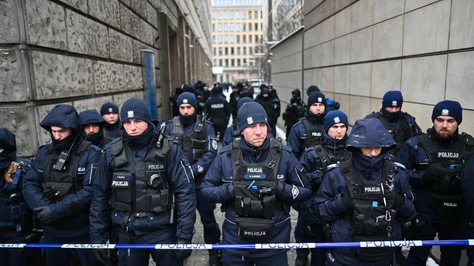 Police officers block the entrances of the Television Information Agency (part of the Public Television, TVP assets network) on 11 January 2024