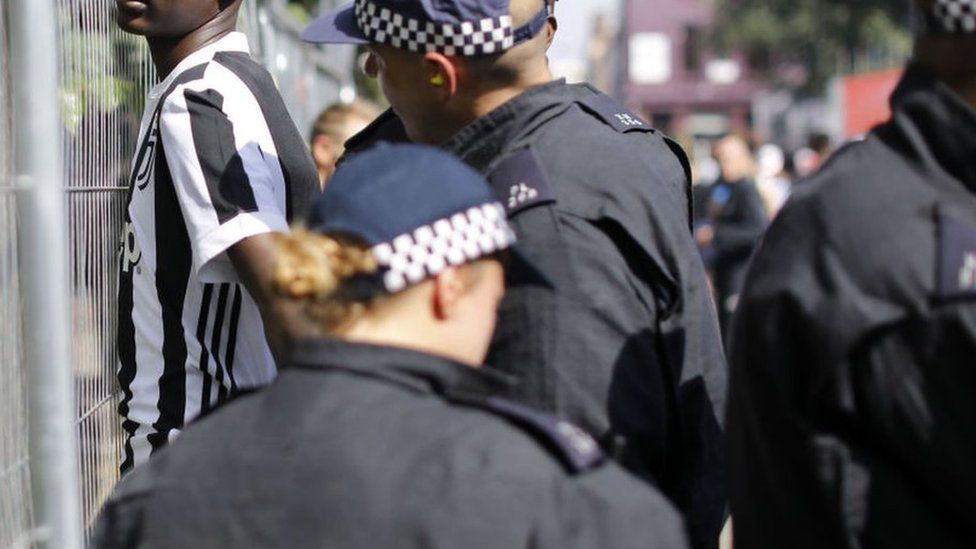 File image of an anonymous black man being stopped and searched by police at Notting Hill Carnival