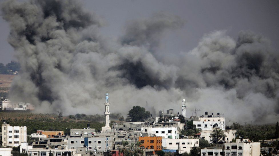 Smoke plumes rising after an Israeli airstrike hit Gaza City, northern Gaza Strip, Thursday, July 31, 2014
