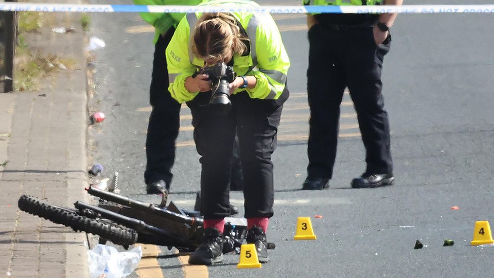 Police photograph a bike at the crash scene