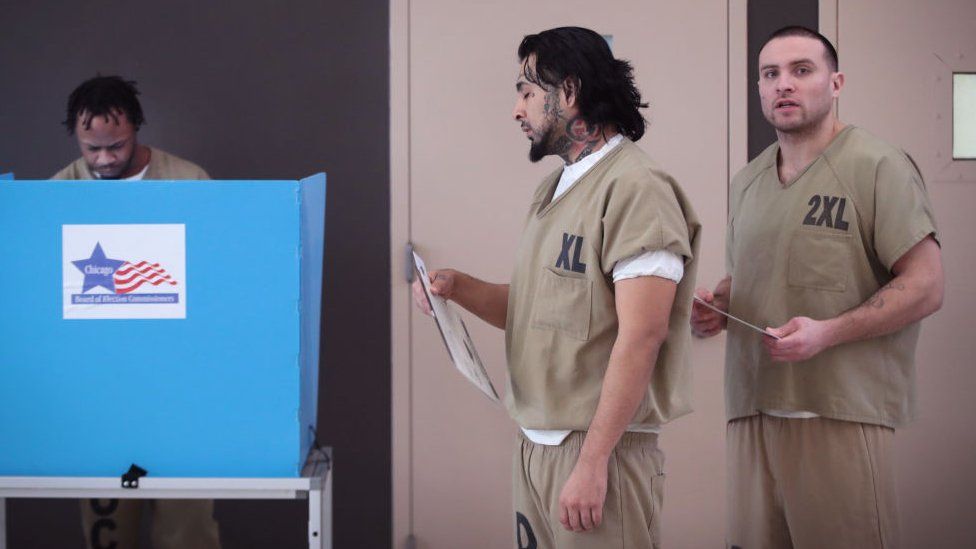 Men cast their ballots at Cook County Jail during the Illinois primary election
