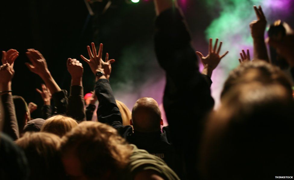 Hands raised at a concert
