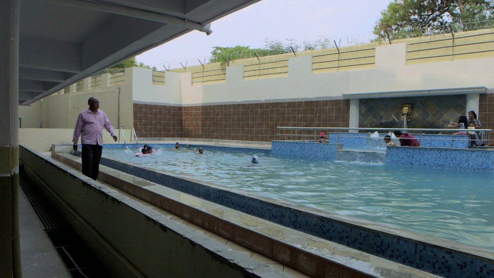 Ayyappa Masagi walking by a swimming pool
