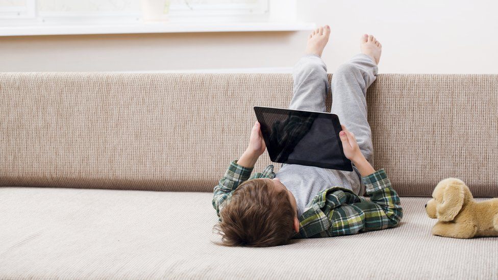 Child on a tablet (Posed by model)