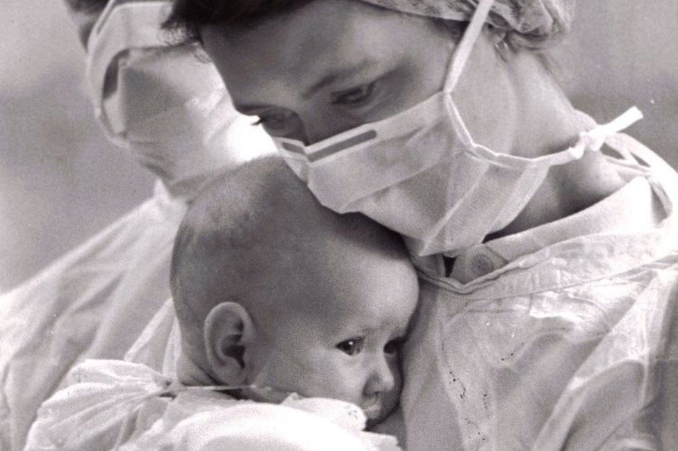 Carol holds baby Kaylee in hospital garb