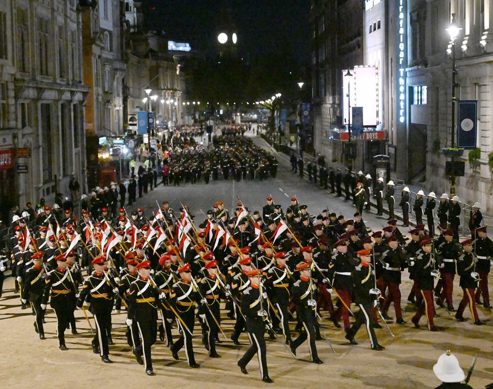Members of the military march in Whitehall during the rehearsal of the Coronation Ceremony.