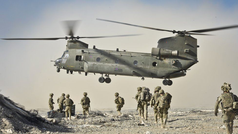 British soldiers and a Chinook helicopter in Afghanistan