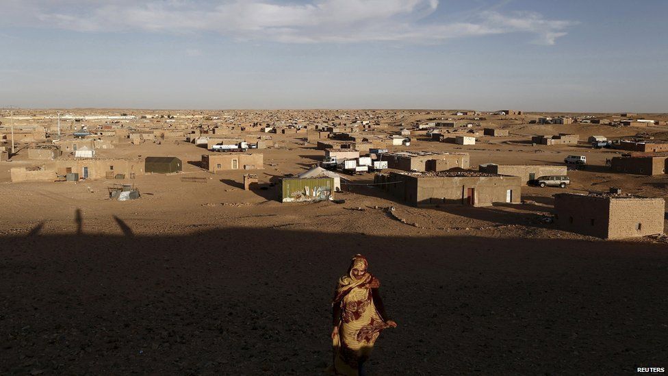 An indigenous Sahrawi woman walks at a refugee camp of Boudjdour in Tindouf