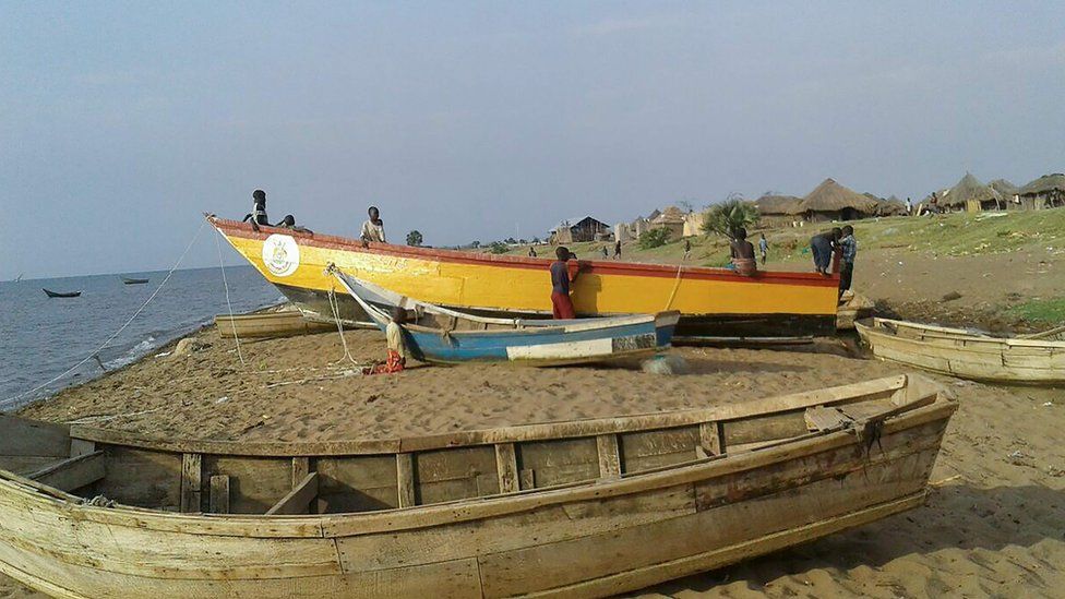 The ill-fated yellow boat is brought back ashore from Lake Albert