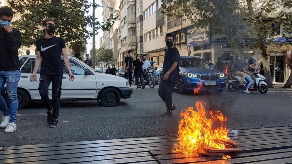 Protesters set a fire as they clash with police during a protest over the death of young Iranian woman Mahsa Amini, who died on 16 September after being arrested in Tehran for not wearing her hijab appropriately, in Tehran, Iran, 08 October 2022. Amini, a 22-year-old Iranian woman, was arrested in Tehran on 13 September by the morality police, a unit responsible for enforcing Iran's strict dress code for women.