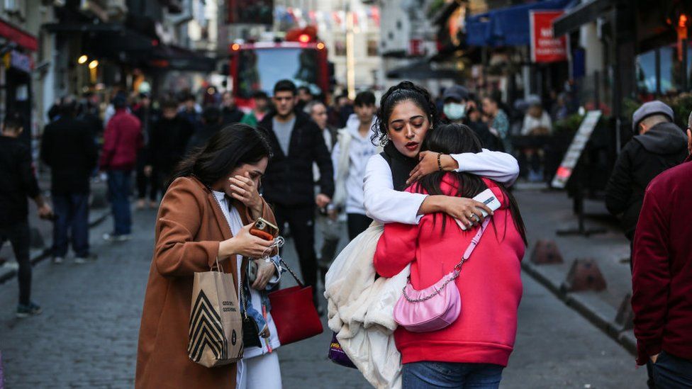 People react after an explosion occurred on Isiklal street in Istanbul