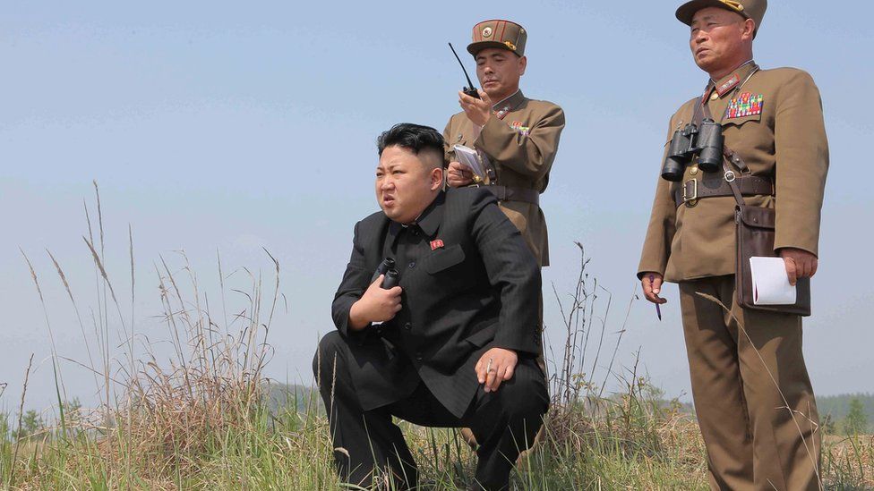 File photo: North Korean leader Kim Jong Un (C) with two military officers