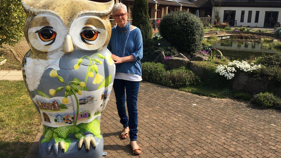 Angie Ashford with her owl sculpture