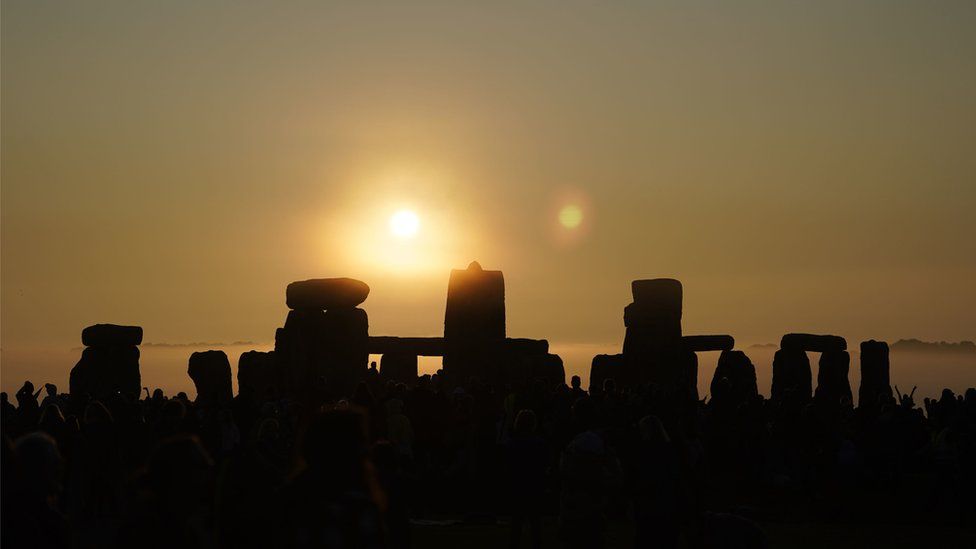 Sun rising above Stonehenge