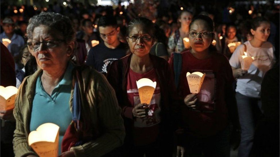 People hold lanterns as hundreds of Salvadorans join a procession to commemorate the anniversary of the murder of six Jesuit priests and two women by an elite army, in San Salvador, El Salvador, 11 November 2017