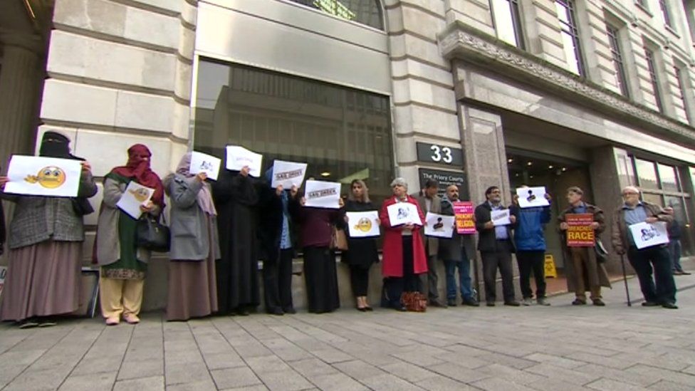 Demonstrators outside the High Court in Birmingham before the hearing