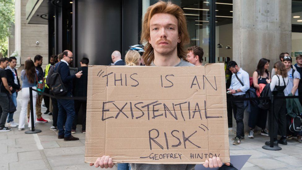 A demonstrator outside UCL where Sam Altman spoke