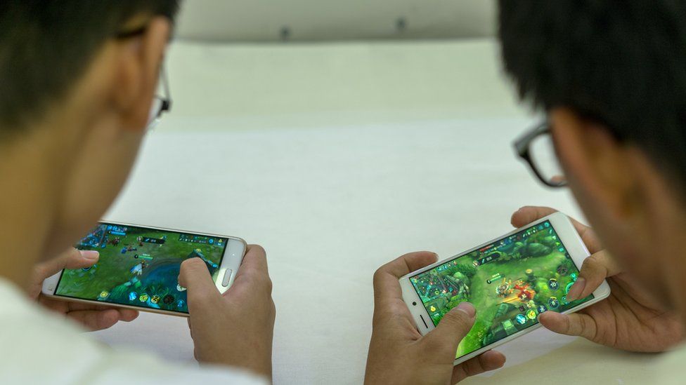 Young players practice the mobile game Arena of Valor, prepared for the battle match held in a shopping mall. Arena of Valor: 5v5 Arena Game, China's most popular mobile game developed by Tencent Inc, which is the world's largest mobile games developer.