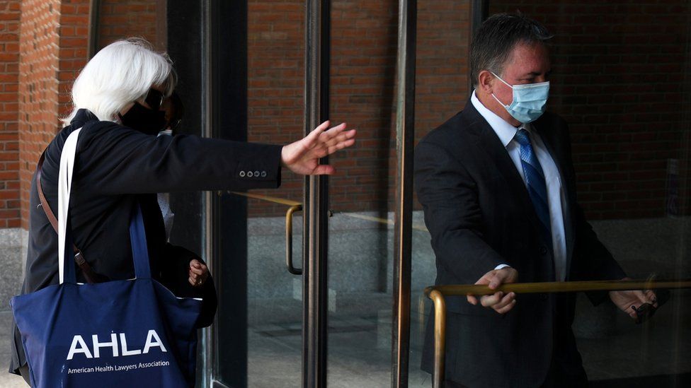 Philip Cooke, right, arrives for sentencing at a Boston court