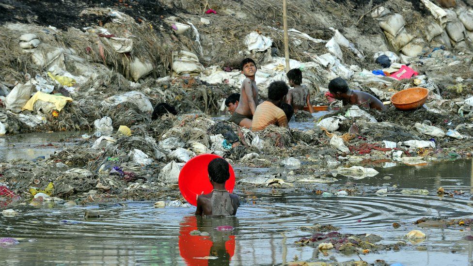 Indian men search for coins and gold in the polluted waters of the Ganga river at Sangam after the Kumbh Mela festival, in Allahabad on April 2, 2013.