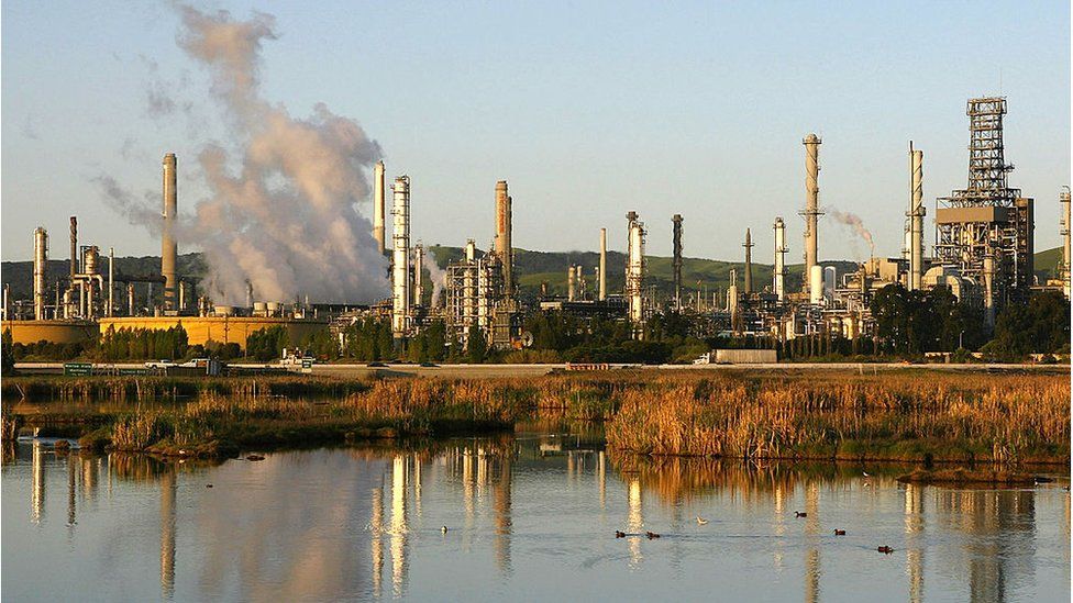 Smoke drifts away from a Shell Oil refinery