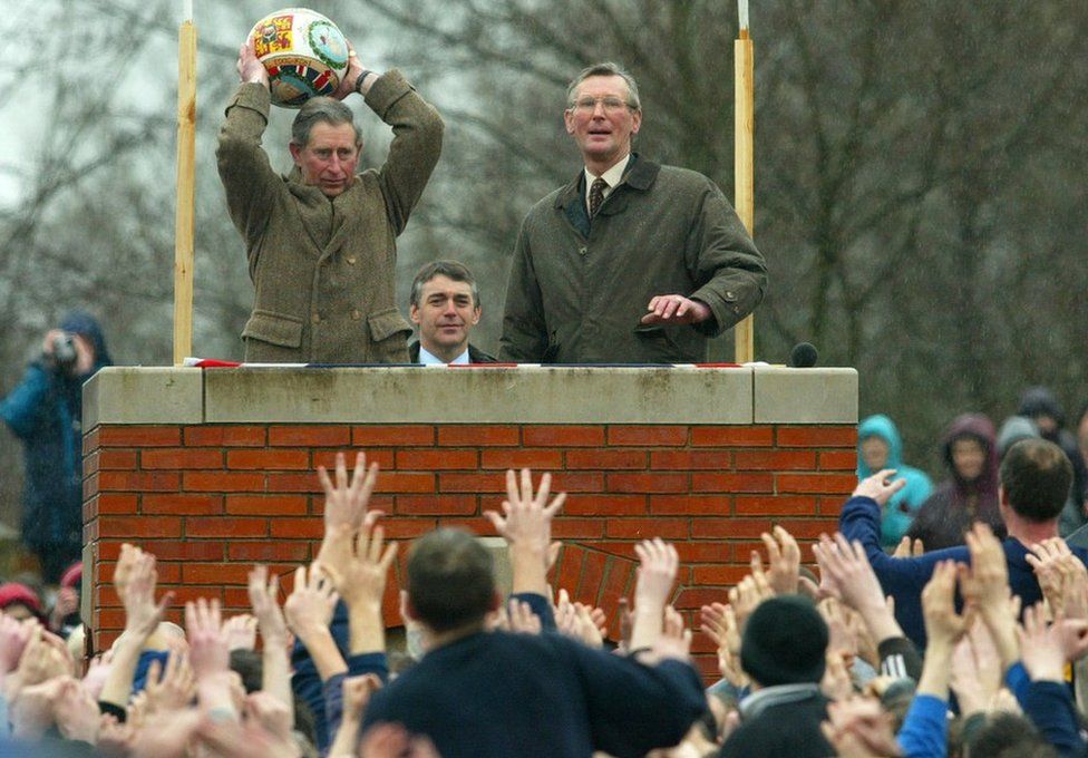Prince Charles prepares to "turn up" the ceremonial ball before starting the ancient Royal Shrovetide Football game, in Ashbourne, Derbyshire