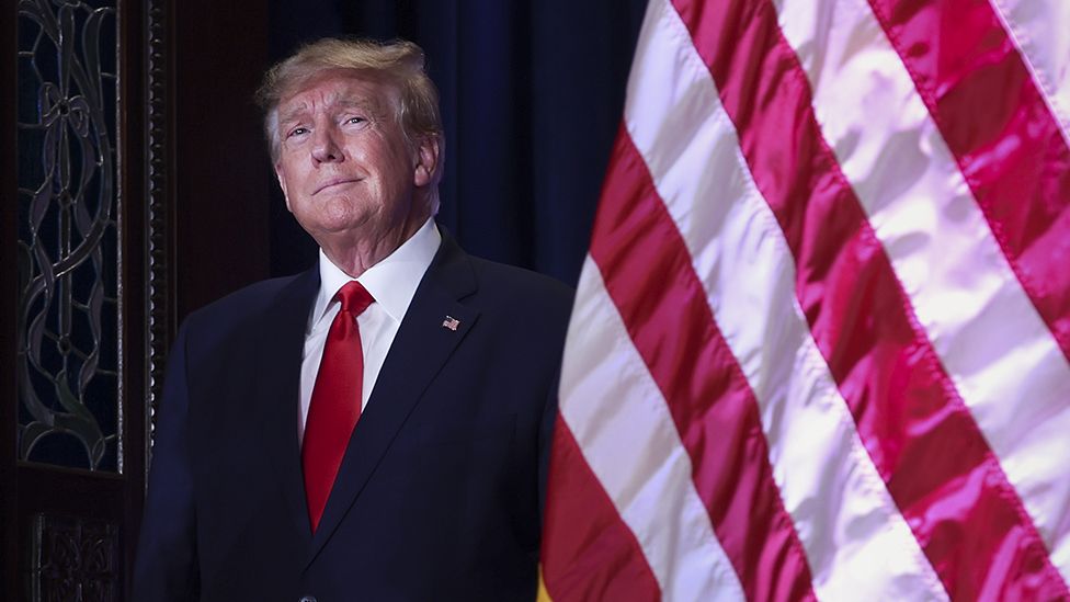 Donal Trump stands before speaking in South Carolina, 28 Jan 23