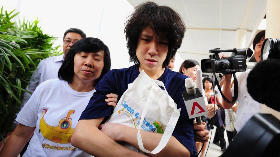 Singapore blogger Amos Yee, accompanied by his mother, outside a court in Singapore, 6 July 2015
