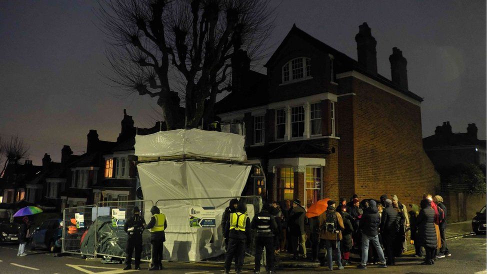 People gathered around the tree