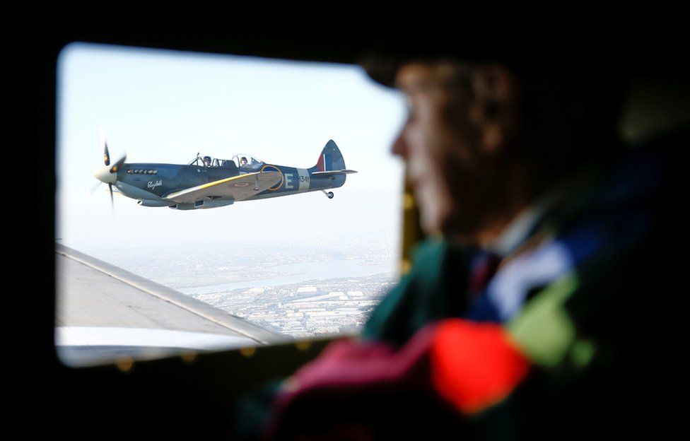 A WWII Spitfire can be seen out of the window of a C47 A Dakota plane, while war veteran Roy Briggs looks on, during Remembrance Sunday commemorations in Dover.