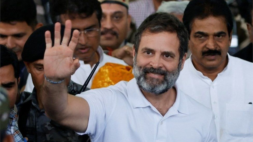 Rahul Gandhi, a senior leader of India"s main opposition Congress party, waves towards his party supporters as he arrives at the New Delhi airport, after he appeared before a court in Surat in the western state of Gujarat, India, March 23, 2023.