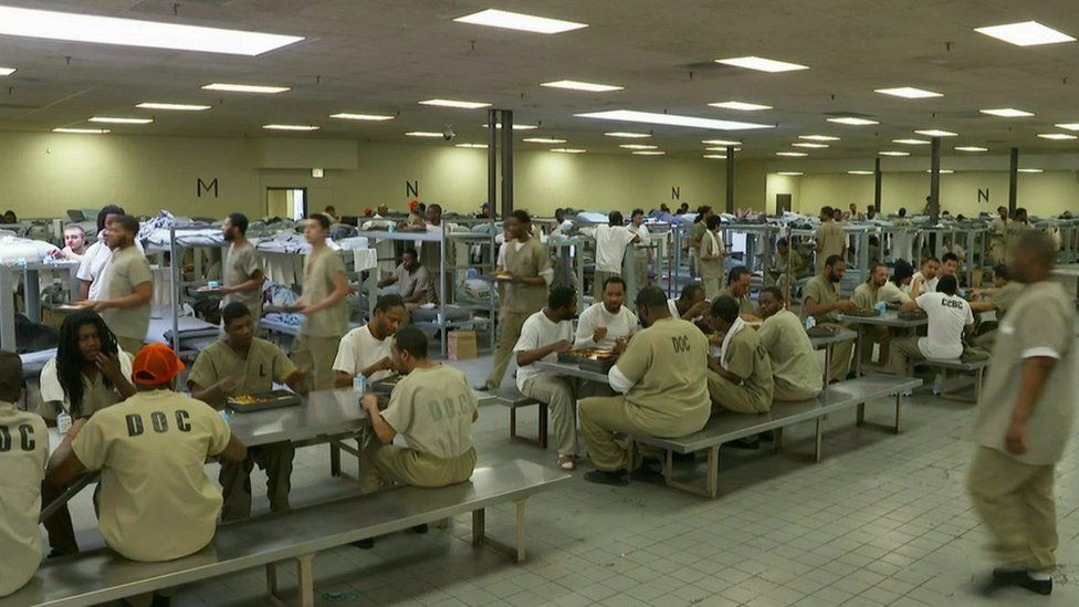 Hundreds of prisoners crammed in one single room for sleeping and eating.