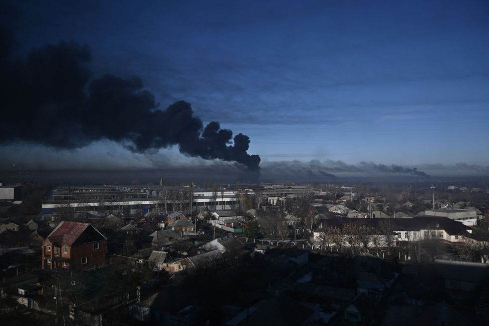 Black smoke rises from a military airport in Chuhuiv near Kharkiv on February 24, 2022