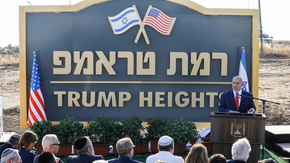 Israeli Prime Minister Benjamin Netanyahu gives a speech before the newly-unveiled sign for the new settlement of "Ramat Trump", or "Trump Heights"